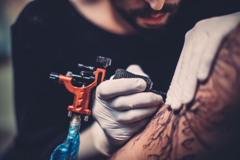 A man performing a tattoo